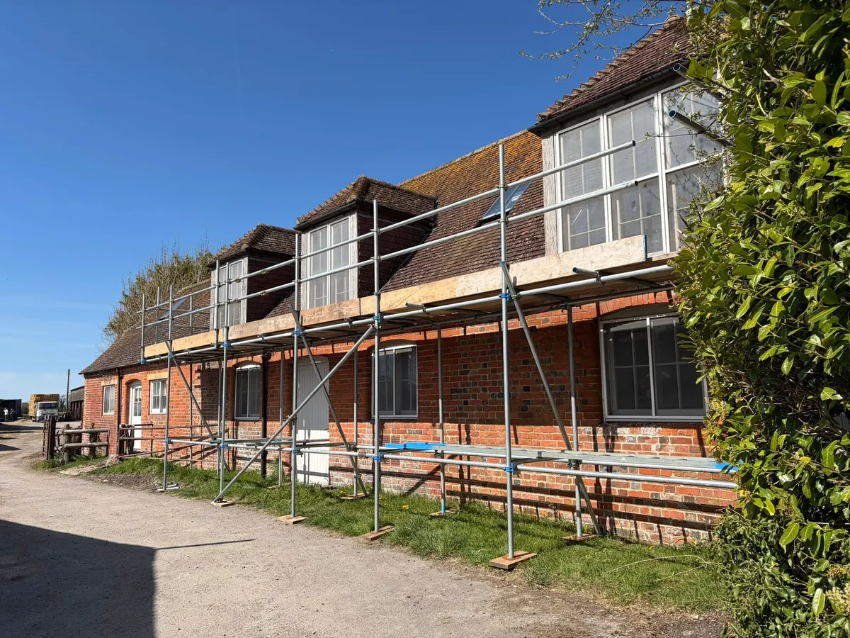 Eaves scaffold beneath a row of dormers