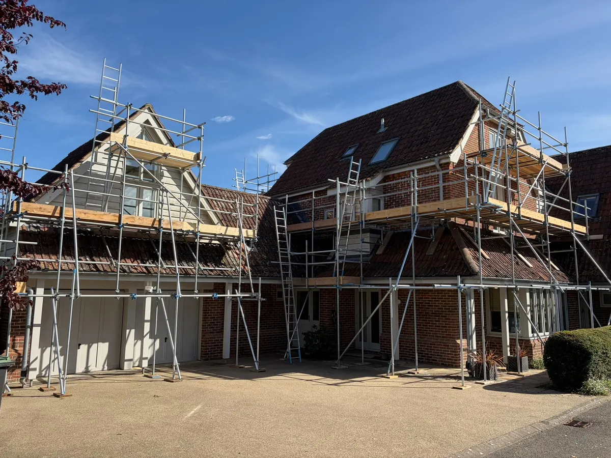 Wrap-around scaffold on a large gabled brick house