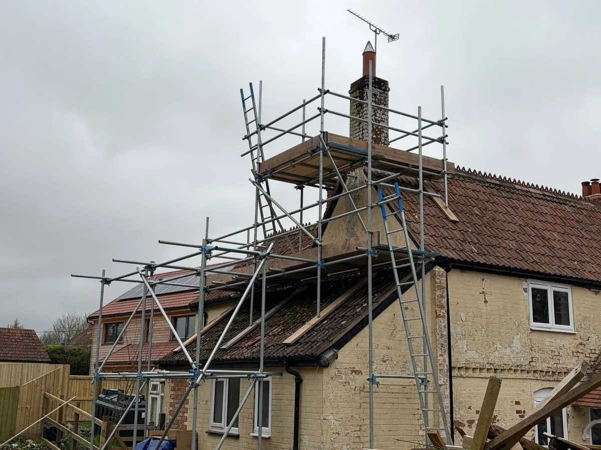Chimney tower on a rendered cottage