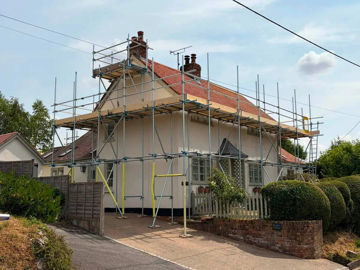 Full wrap for roof works on a large red-roofed house