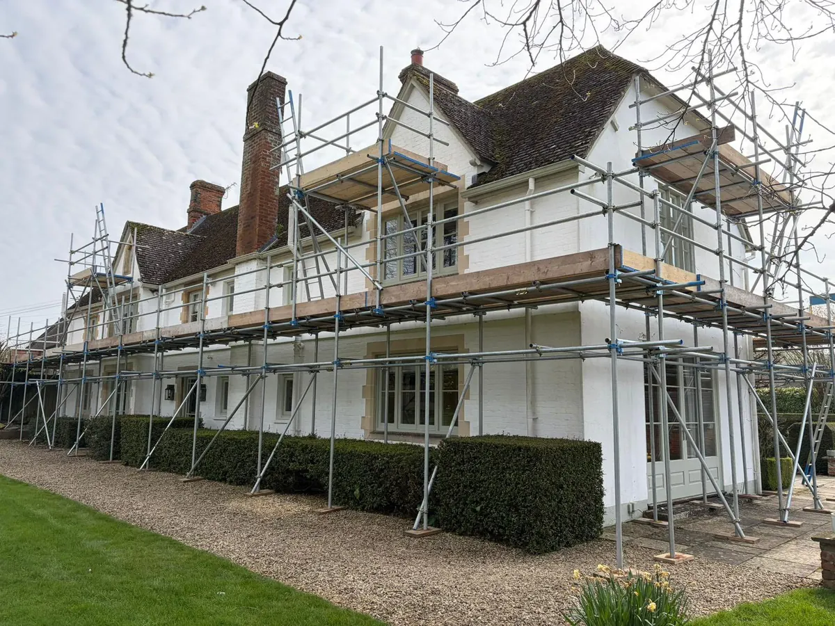 Scaffold along the full front of a large white house